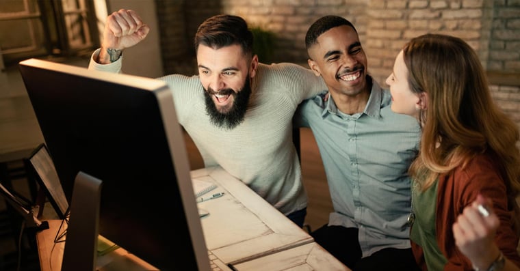 happy change managers looking at a computer monitor
