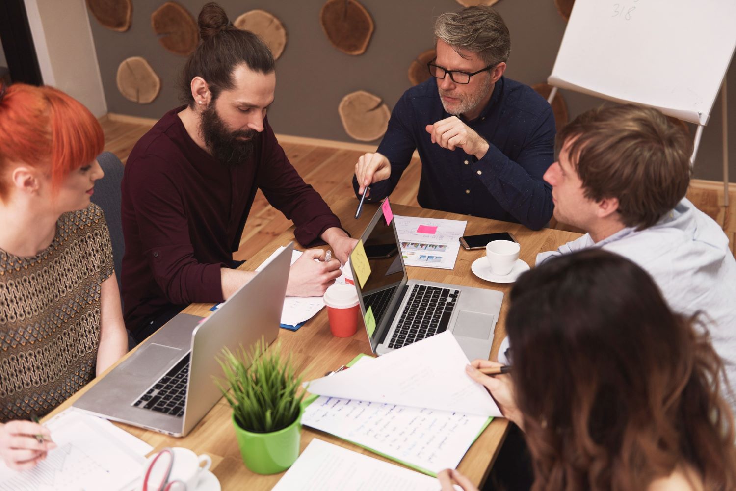 project managers analyzing cost efficiency - iTalent Blog