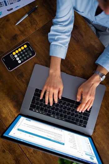 project manager typing at a laptop - iTalent Digital Blog